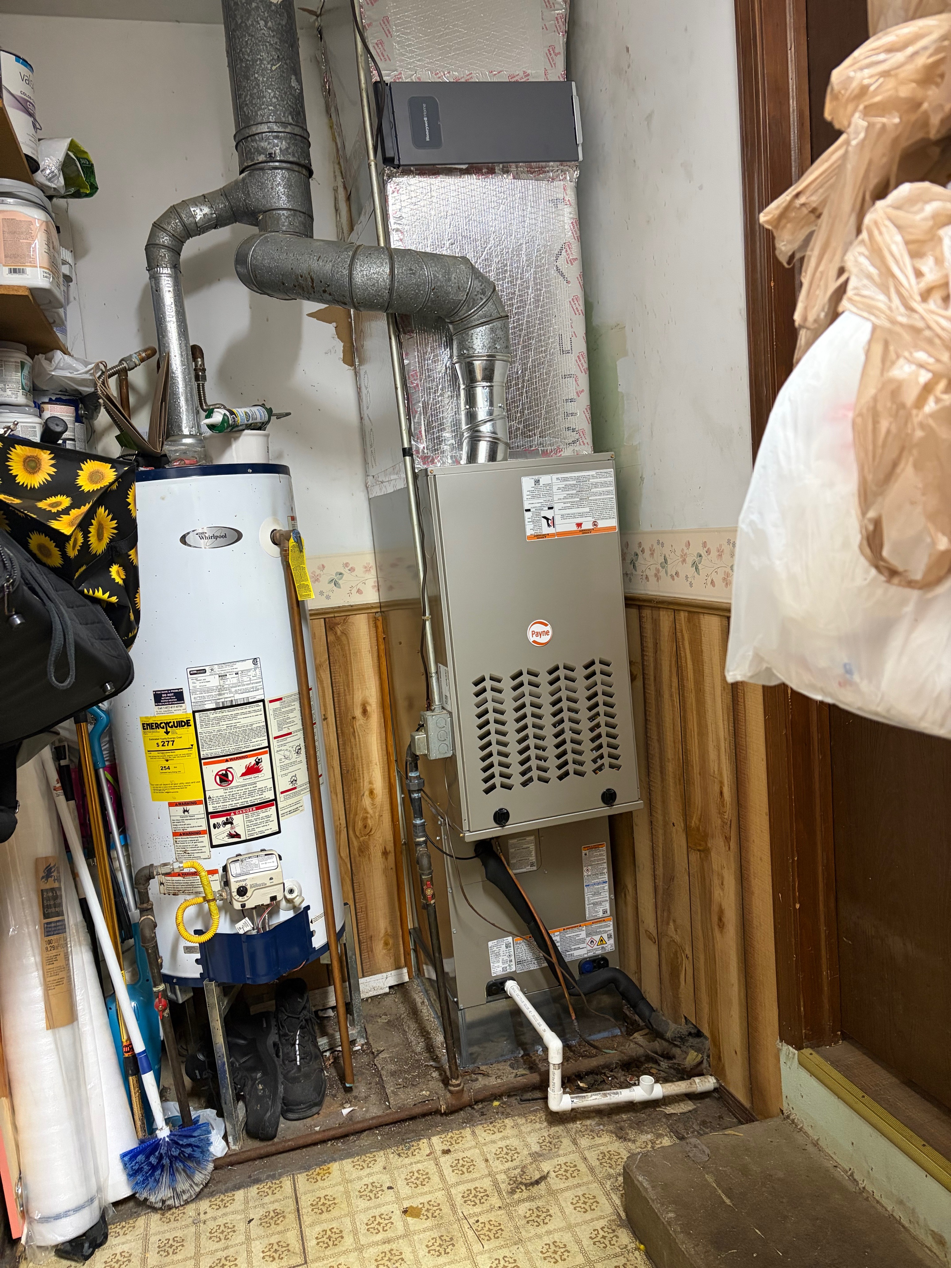 Payne furnace installed indoors next to a water heater