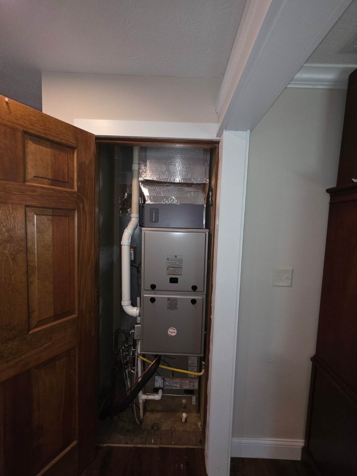 High-efficiency Payne furnace installed in a hallway closet